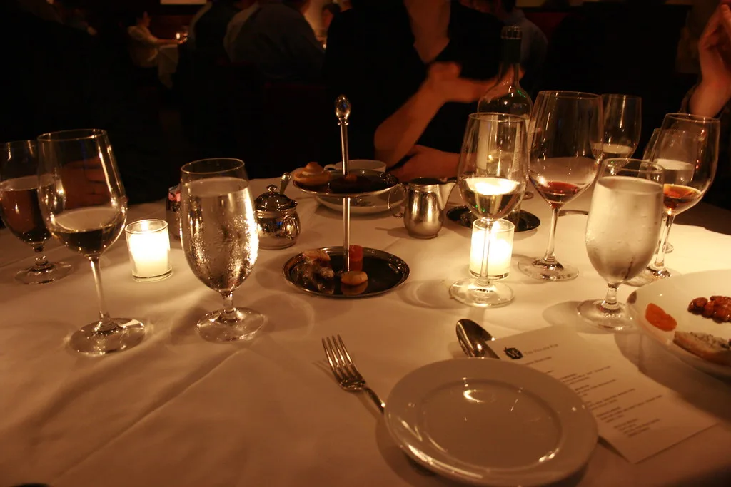 Friends raising glasses over a candlelit dinner table