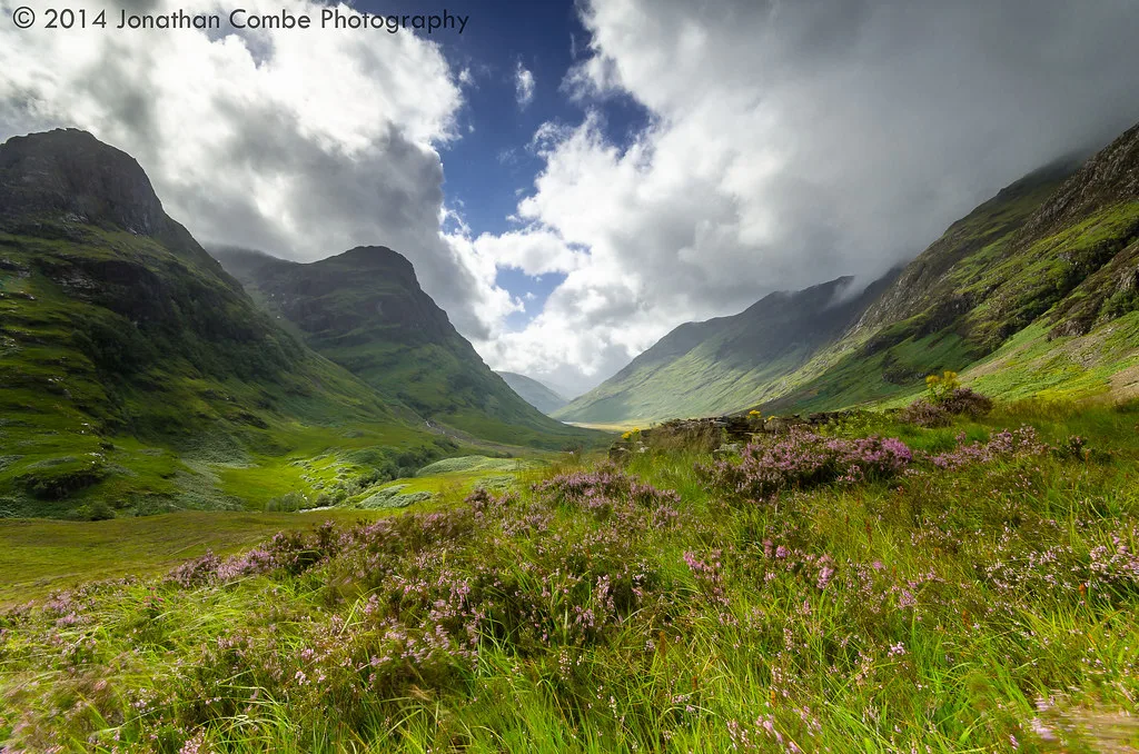 Moody mountain valley with passing rain showers