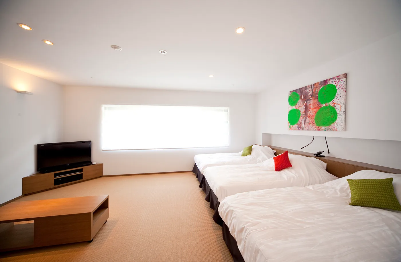 Bright guest room with two single beds and a window bench